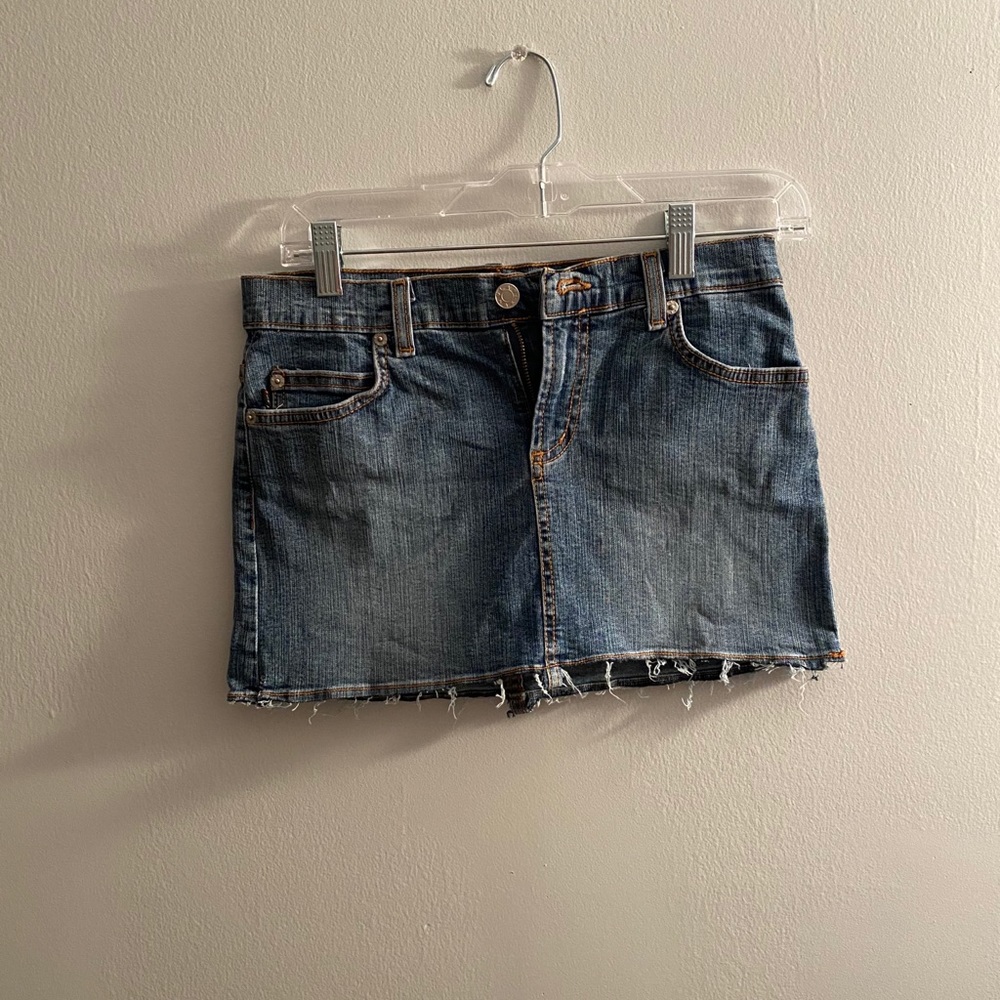 Distressed denim mini skirt.